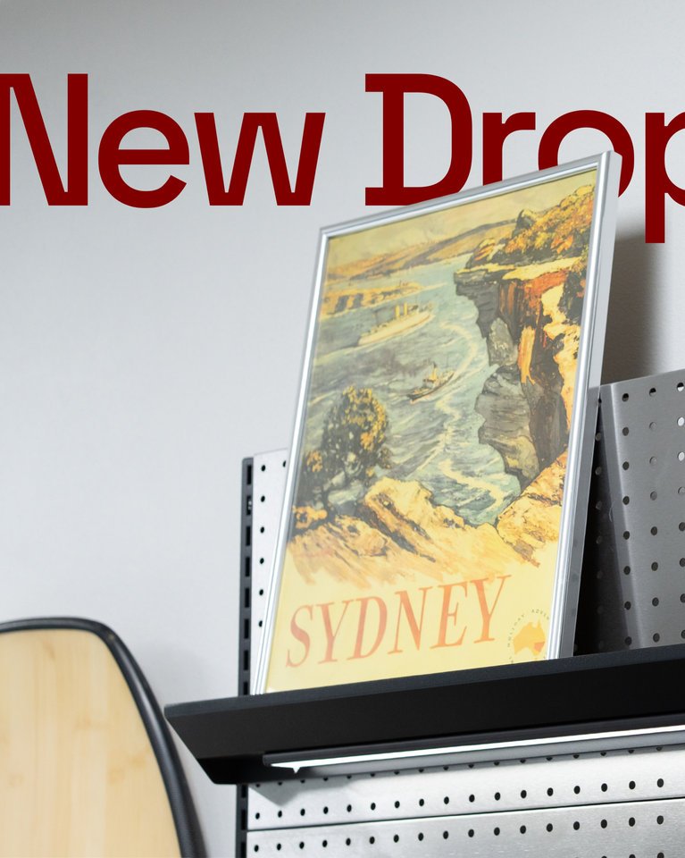 A Sydney illustration resting on a black display ledge attached to a PegGrid panel beneath red New Drop lettering.